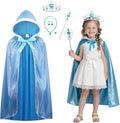 A children's princess costume set shown on a white background, including a blue hooded cape with white trim and bow, a white dress, silver tiara with blue gem, matching wand, necklace, earrings, and a small girl modeling the outfit and wearing the tiara.