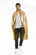 A man modeling a shiny metallic gold cape over a white t-shirt, dark jeans, and white sneakers, photographed against a seamless white studio background.